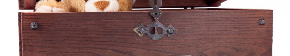 Teddy bear poking its head out of a wooden box