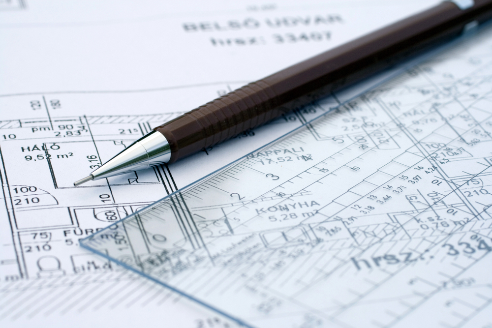 Pen on a detailed diagram next to a ruler