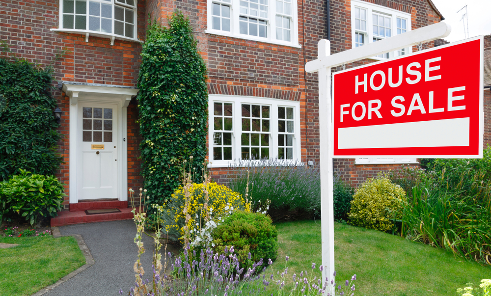 House for sale sign in front of a home