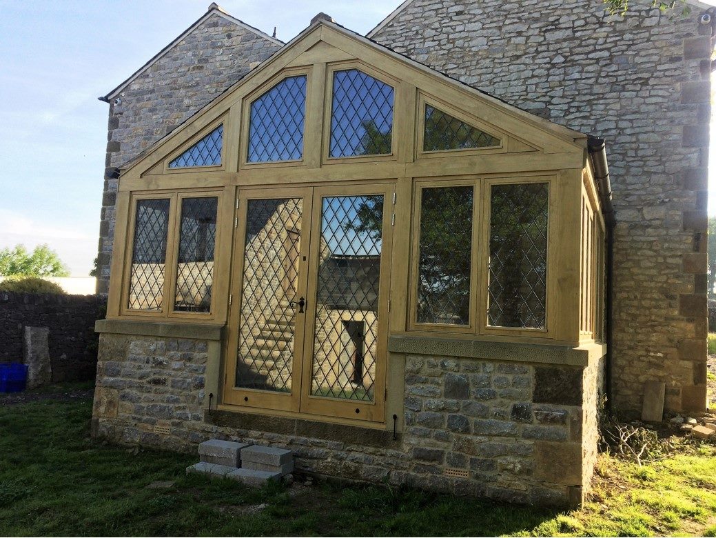 A wooden porch attached the outside of a home