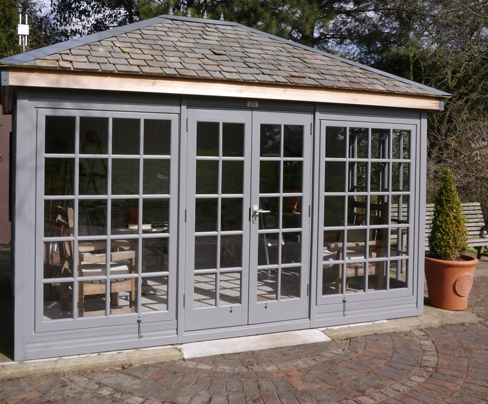 A wooden conservatory painted in grey